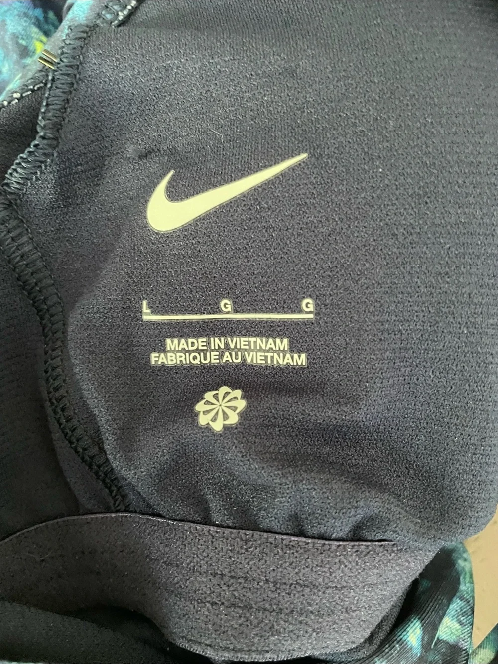 Nike women’s one piece swimsuit abstract watercolors print with a swoosh logo .